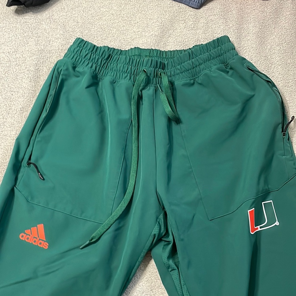 Green University of Miami logo sweatpants.
